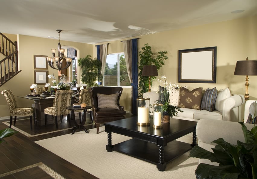 Room with blue and brown curtains, oatmeal colored carpet and brown wingback chair