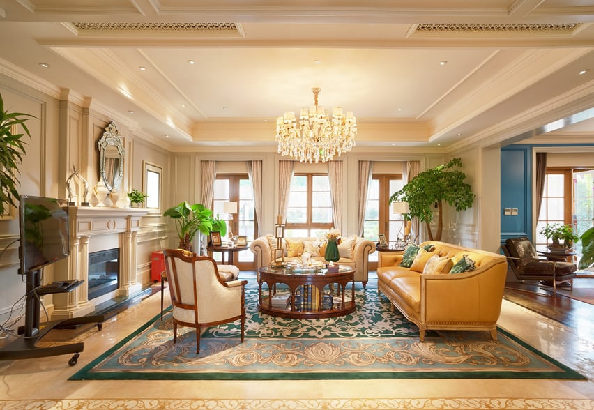 Room with glass chandelier, yellow sofa and pleated curtains