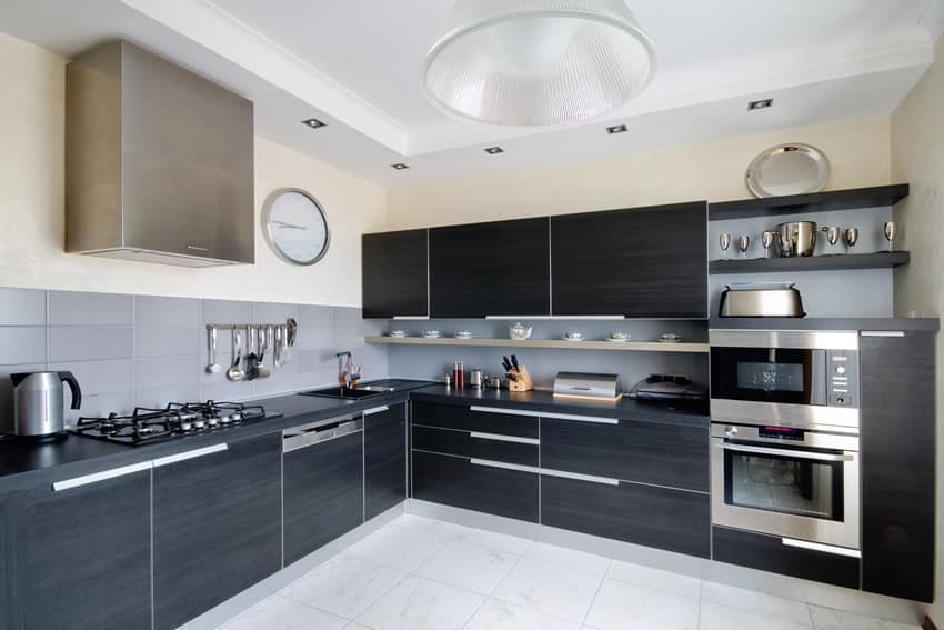 Kitchen with black laminated cabinets, steel pulls and shelving