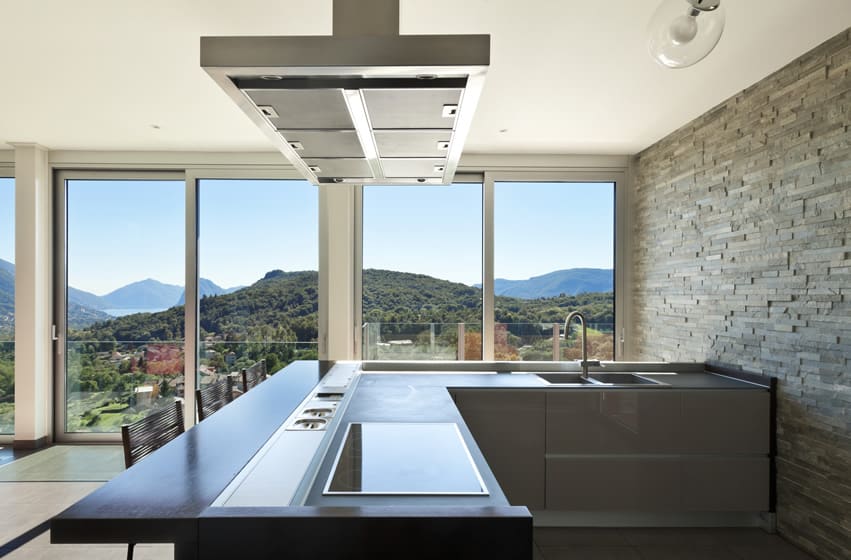 Small l shaped kitchen with impressive view of hills and lake