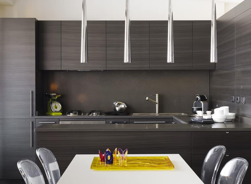 Kitchen with wood laminate counters, handleless base cabinets