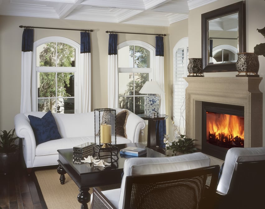 Room with ebony plank floors abd white loveseat