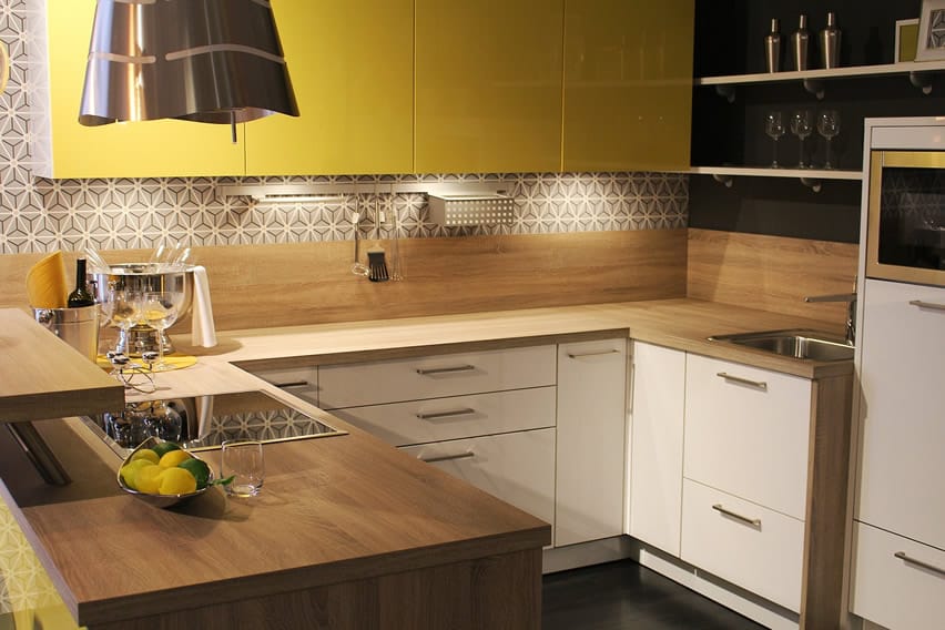 Wood counter u-shaped kitchen with yellow cabinets