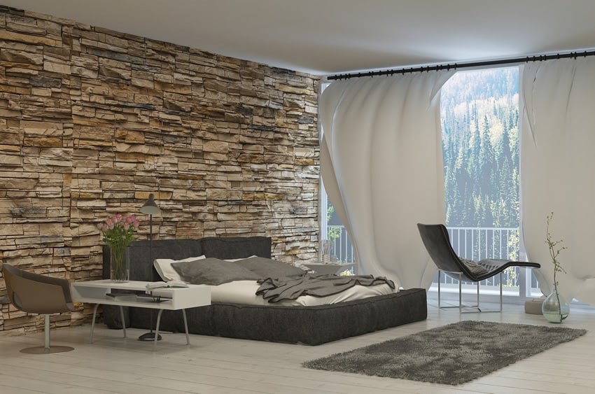 Amazing bedroom with rock accent wall and forest view