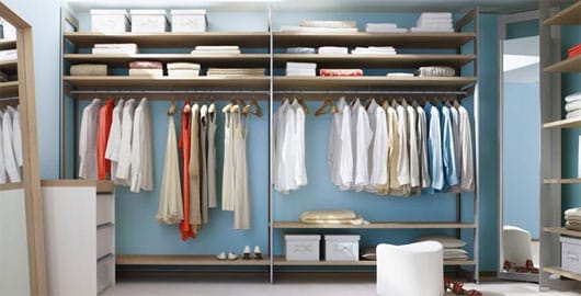 Baby blue walk in closet with mirrors