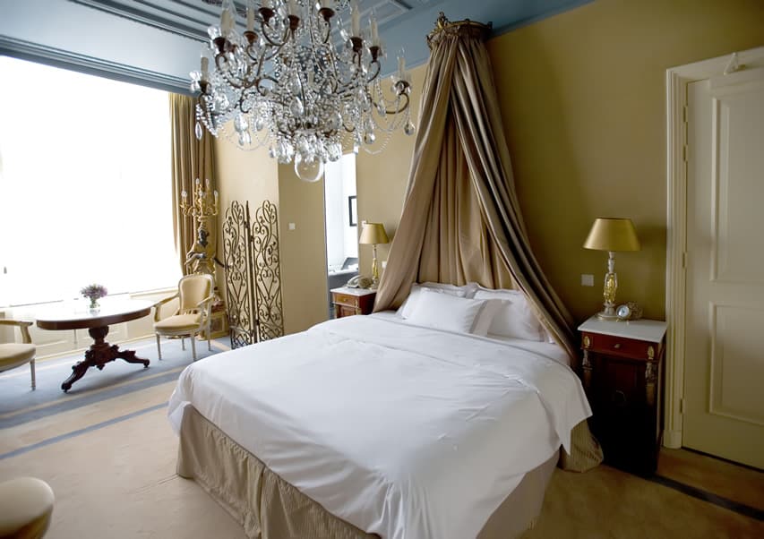 Powder blue ceilings with beige walls with beige bed canopy