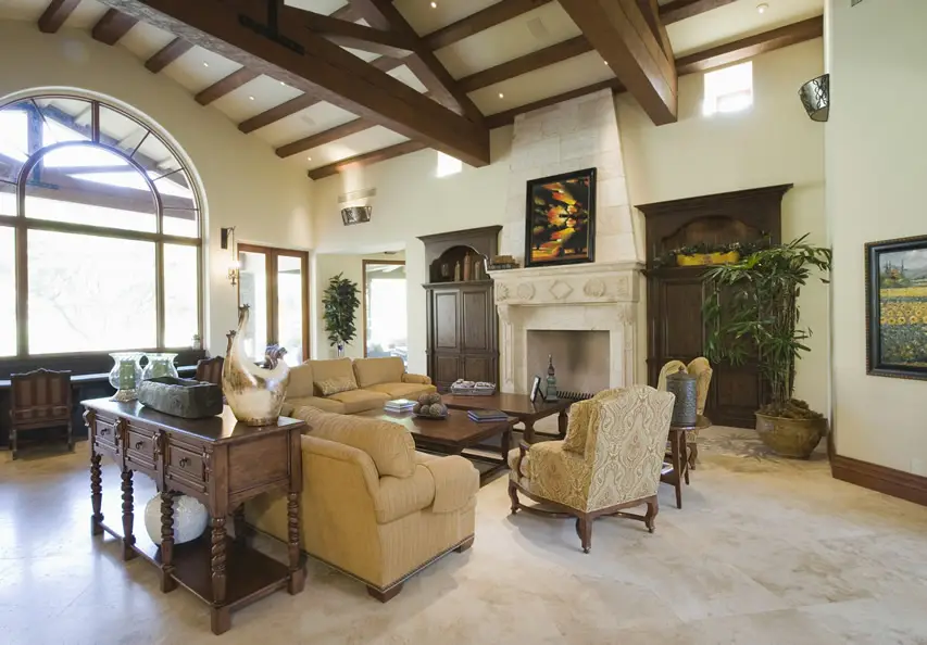 Room with arched windows, beige fabric sofas and two wood center tables