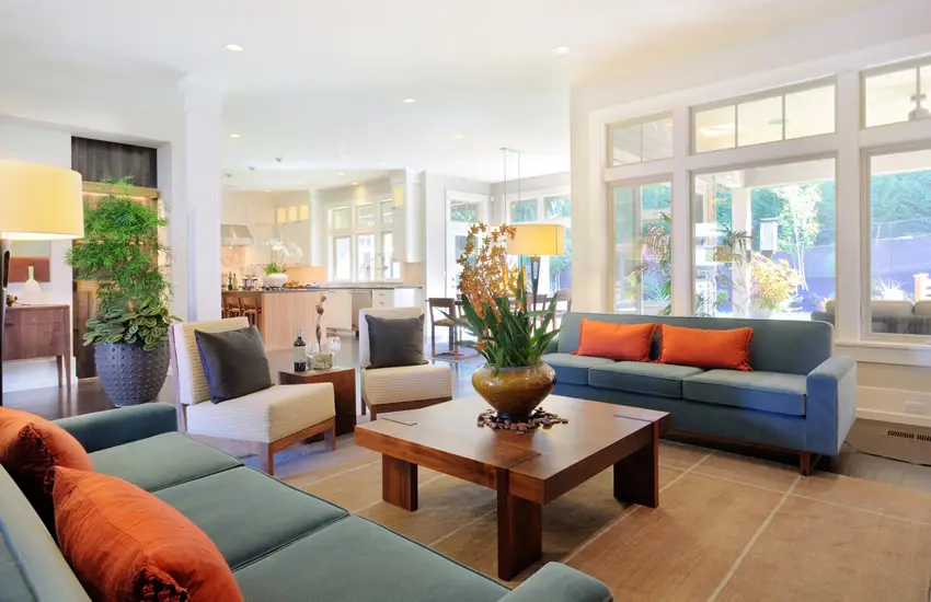 Midmodern Century inspired room with blue gray sofas with orange suede pillows