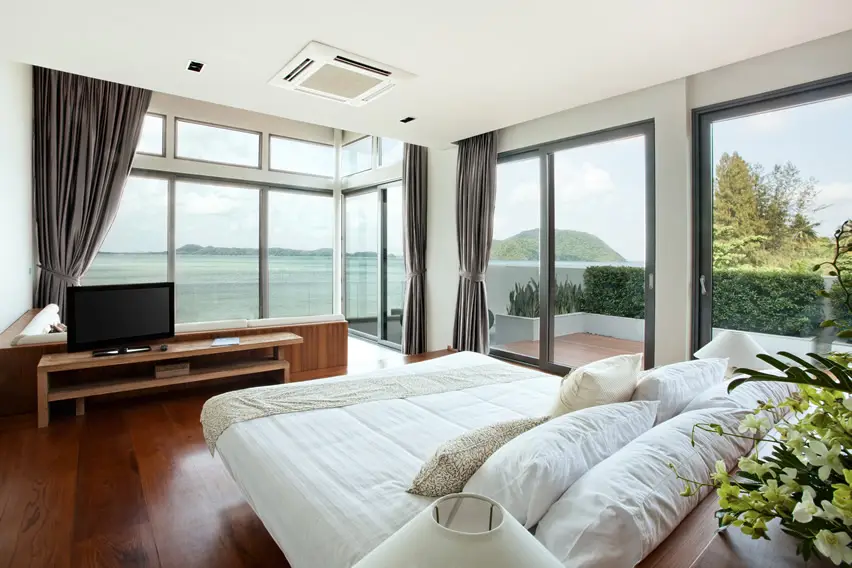 Bedroom with solid oak floors and a floating platform bed with an ocean view