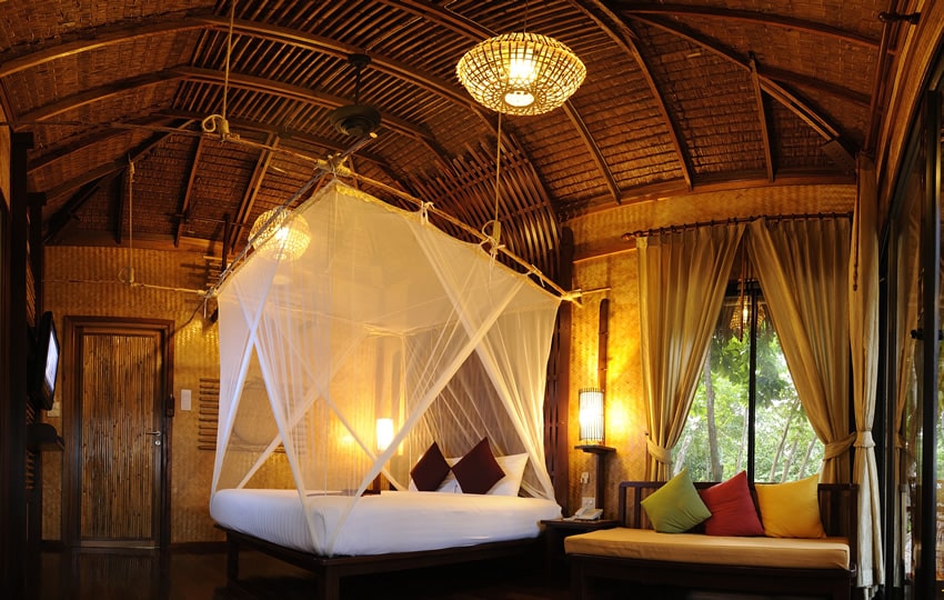 Vacation villa with curtained bed