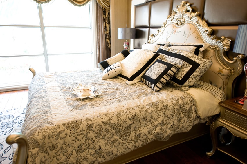 Decorative headboard and light gray linen beddings