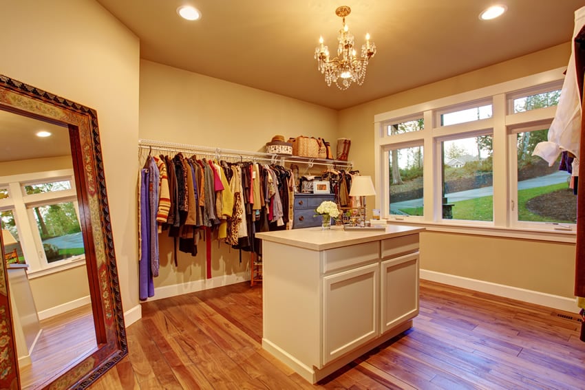 Bright room with chandelier and clothes rack