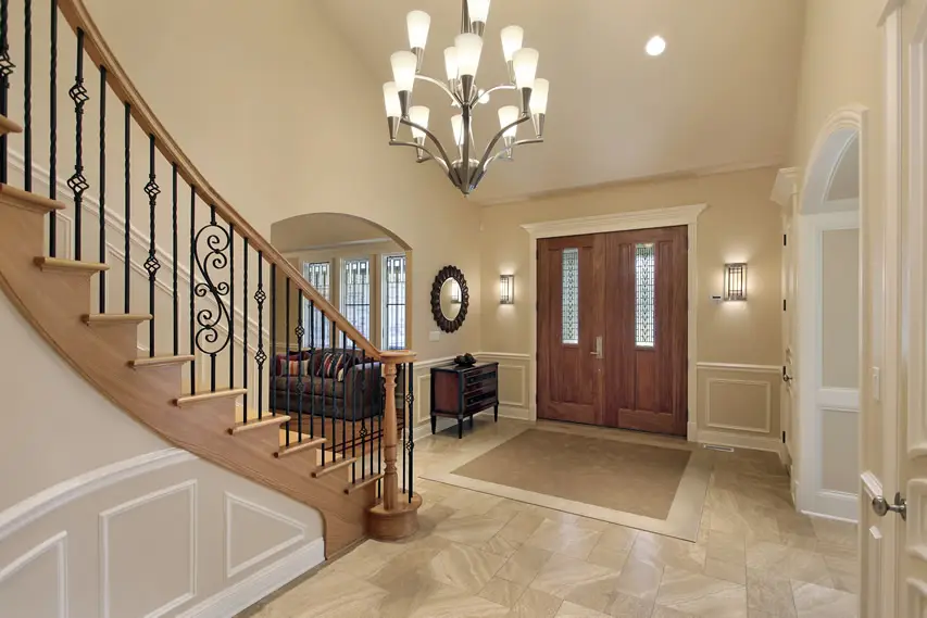 Transitional style foyer with white moldings and sandstone flooring