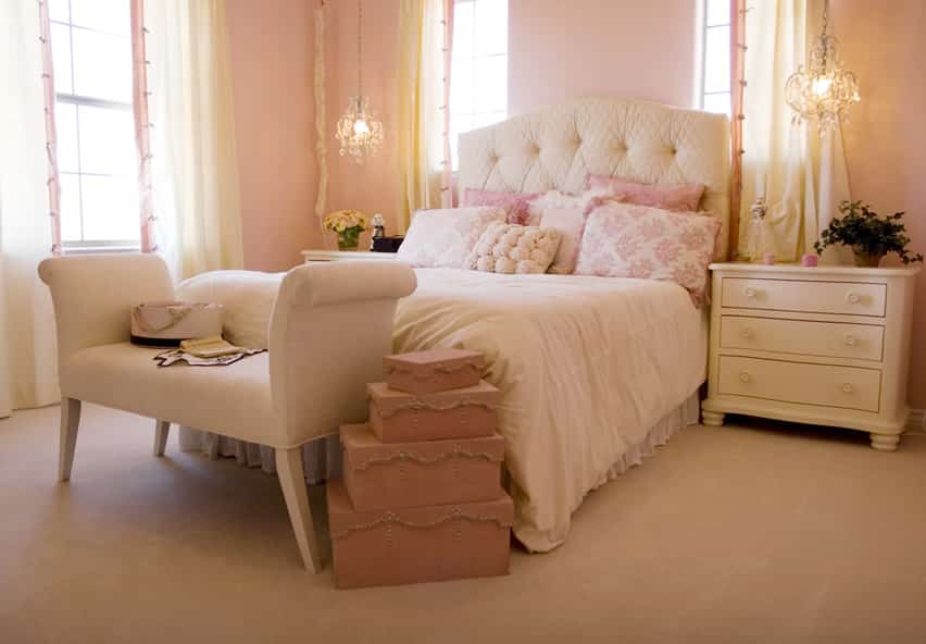 Elegant pink bedroom with cream headboard and furniture