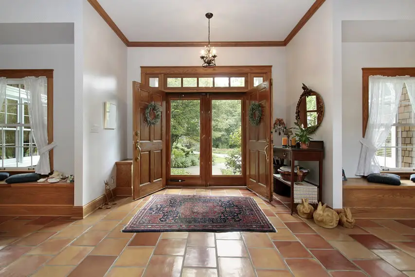 Foyer with terracotta flooring and double wood door