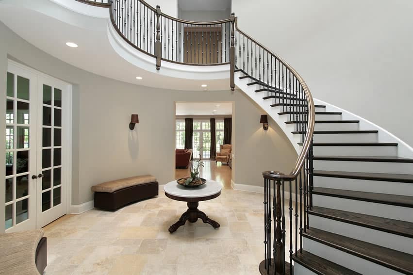 Foyer entry with circular staircase, seat benches and table