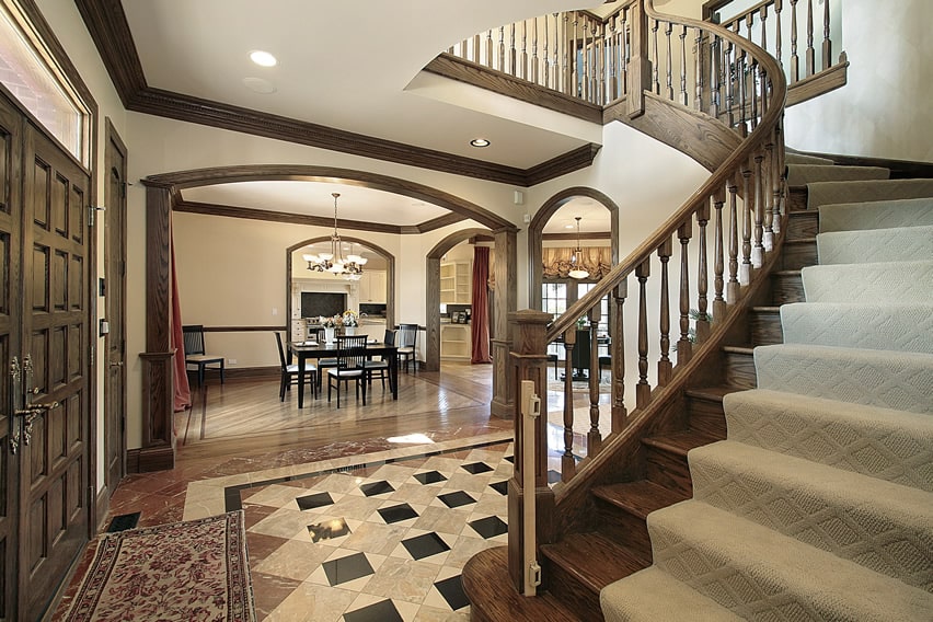 Foyer with wood staircase and white carpeting