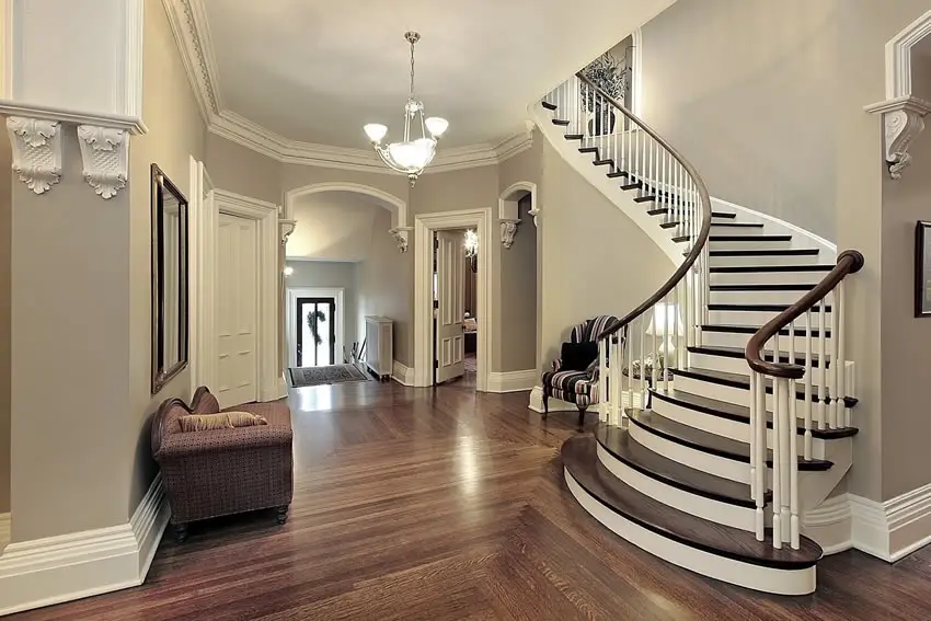 Foyer with grey walls and mahogany floors