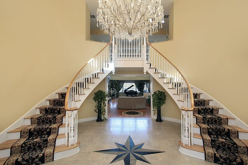 Foyer with double curved staircase and large chandelier