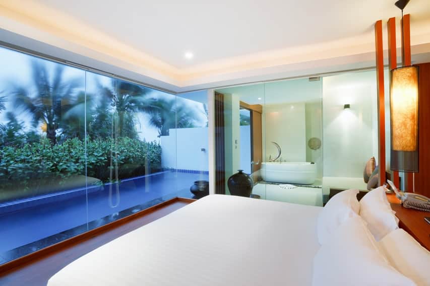 Resort room with frameless window, platform bed and mahogany wall