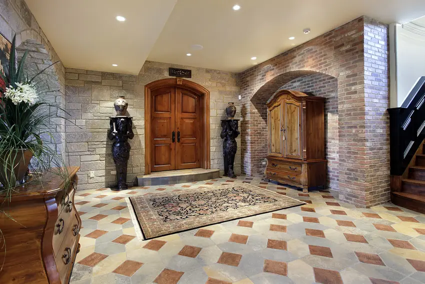 Grand foyer with masonry stone walls and checkered floors