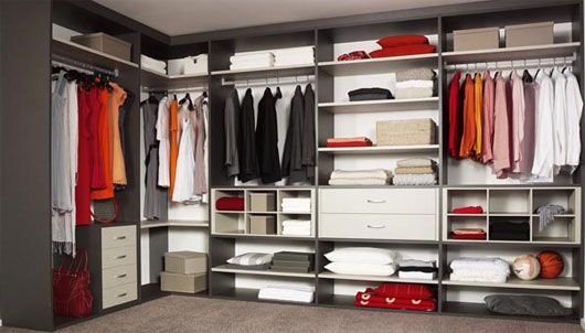 Grey walk in closet with floor to ceiling shelving