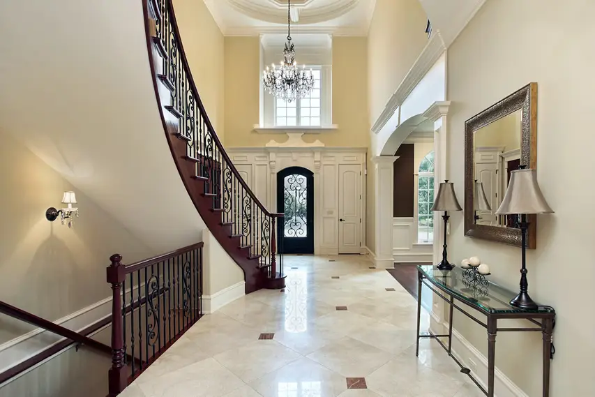 Home with grand door, staircase and travertine flooring