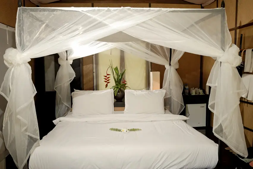 Honeymoon suite with sheer canopy drapery and paneled walls