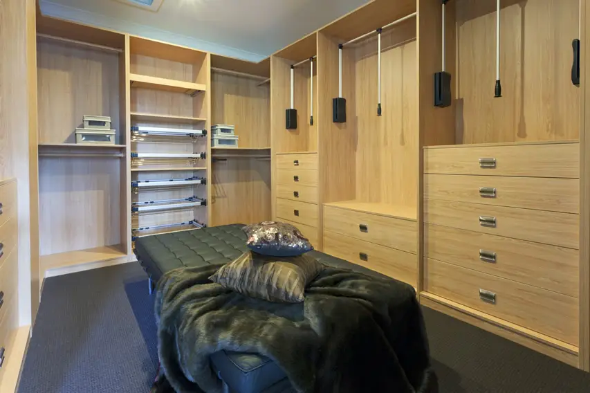 Large seat and ottoman inside a walk-in wardrobe
