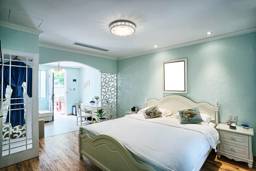 Light blue room with large bed