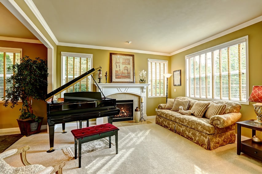 Living room with fireplace and grand piano
