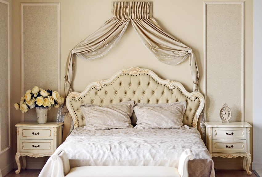Classic French styled furniture pieces with large oatmeal colored bed