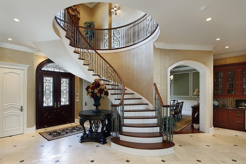 Luxury foyer with spiral staircase and entry table