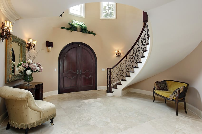Luxury foyer with arched doorway, table and furniture