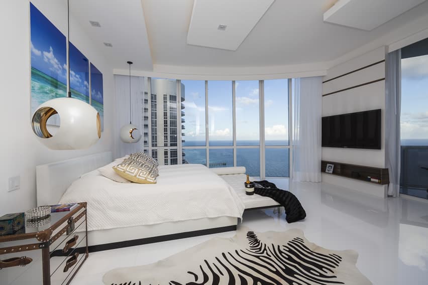 Stylish bedroom in high rise apartment with ocean view