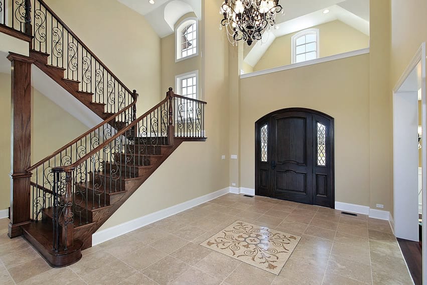 Upscale foyer in home with wood staircase