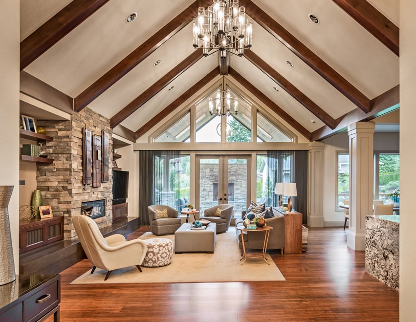 Upscale living room with vaulted ceiling, wood flooring and fireplace
