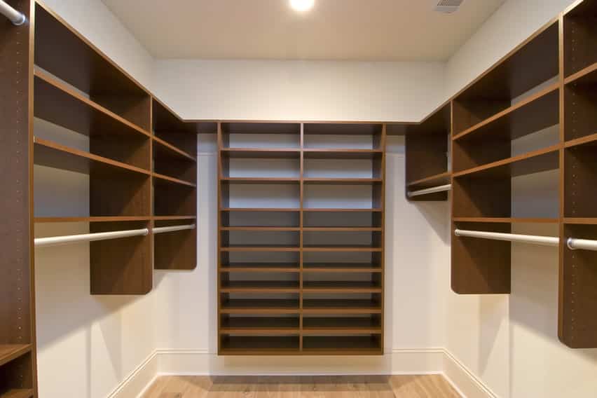 Walk in closet with basic storage for shoes and clothes racks