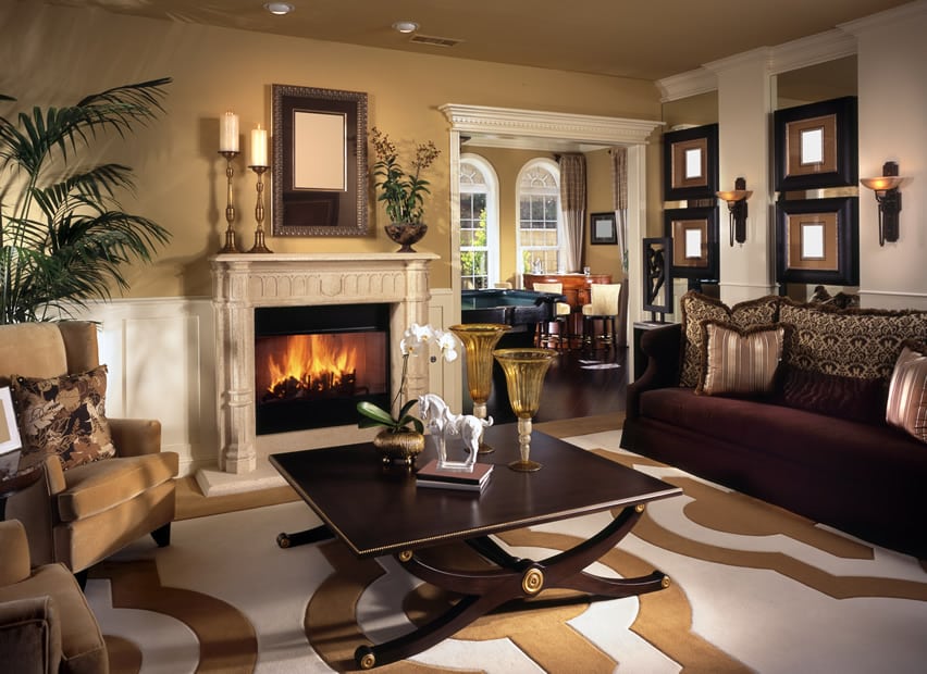 Room with dark maroon velvet, x-leg table and brown and white carpet