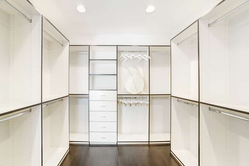 White walk in closet with hard wood floors