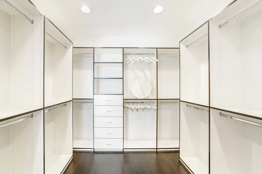White closet with dark hard wood floors