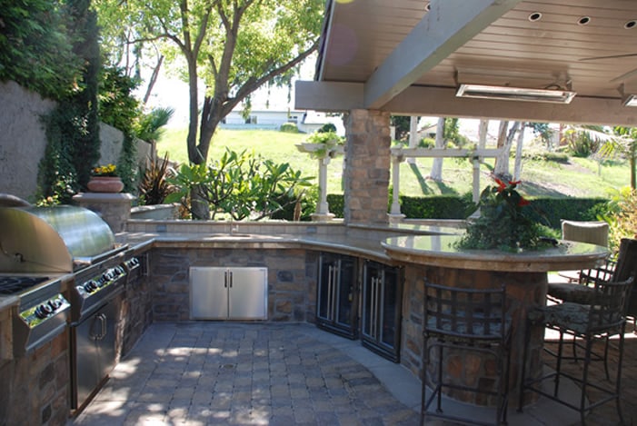 Large kitchen with curved counter and masonry stone floors