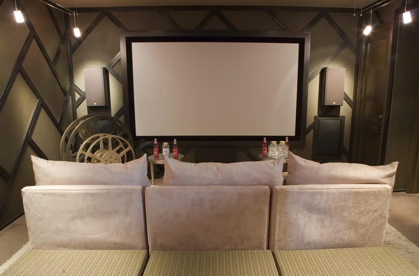 Media room with comfortable couch and tables