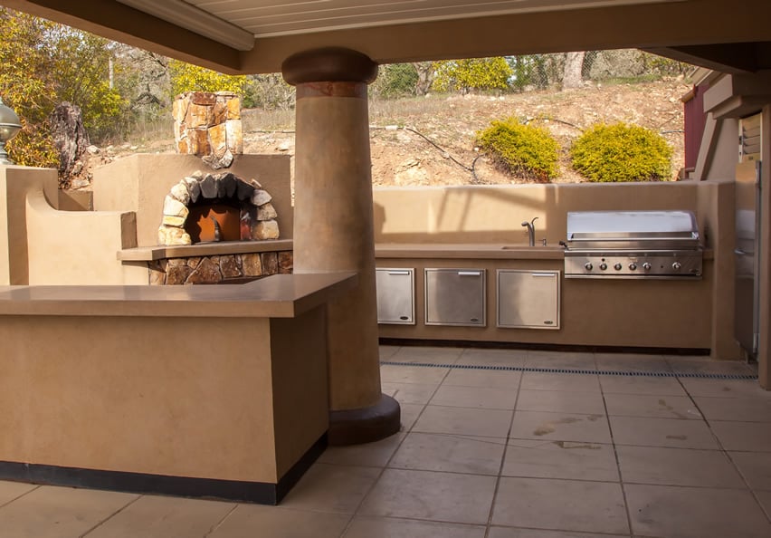Mediterranean style kitchen with beige painted column and outdoor oven