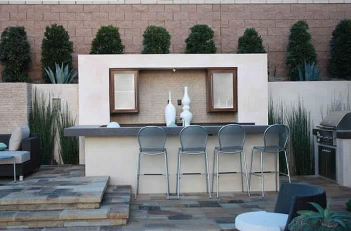 An open patio space with kitchen and built in shelves