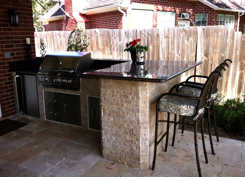 Patio outdoor kitchen with counter top and bar stools