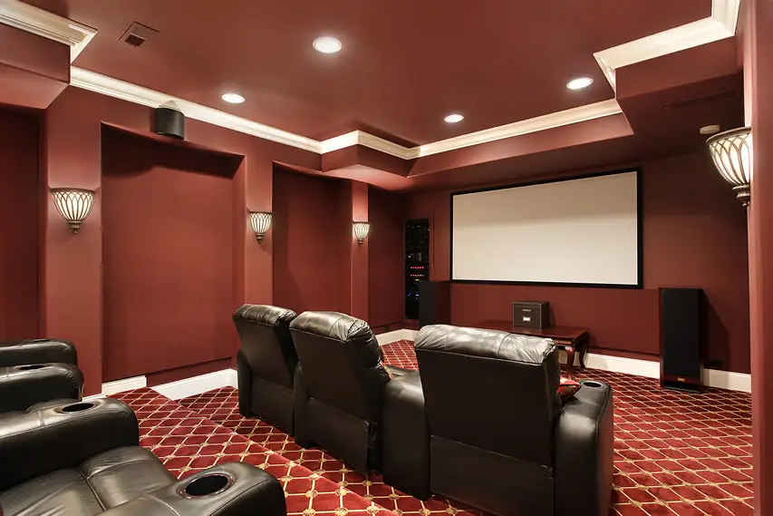 Red home theater with brown leather chairs