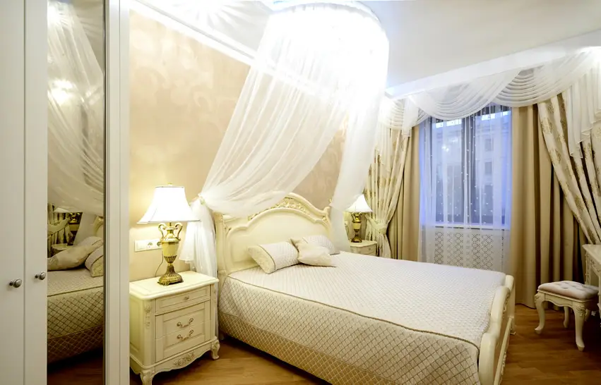 Small bedroom with sheer canopy bed curtain