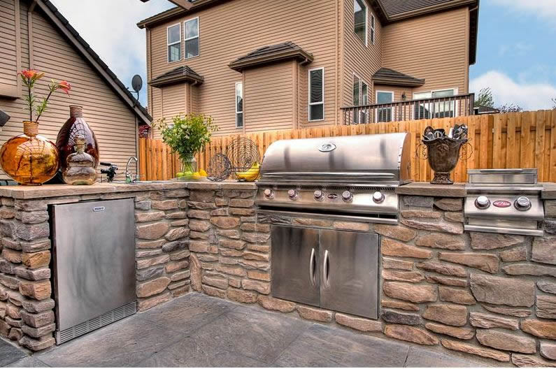 Stainless steel outdoor kitchen with stone structure