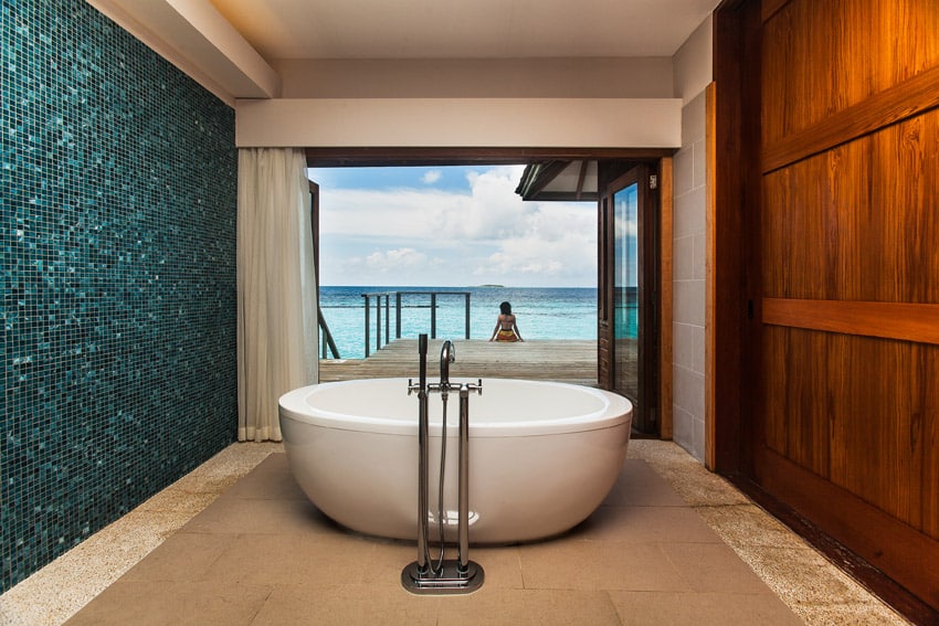 Amazing oceanview bathtub with aqua tile acent wall